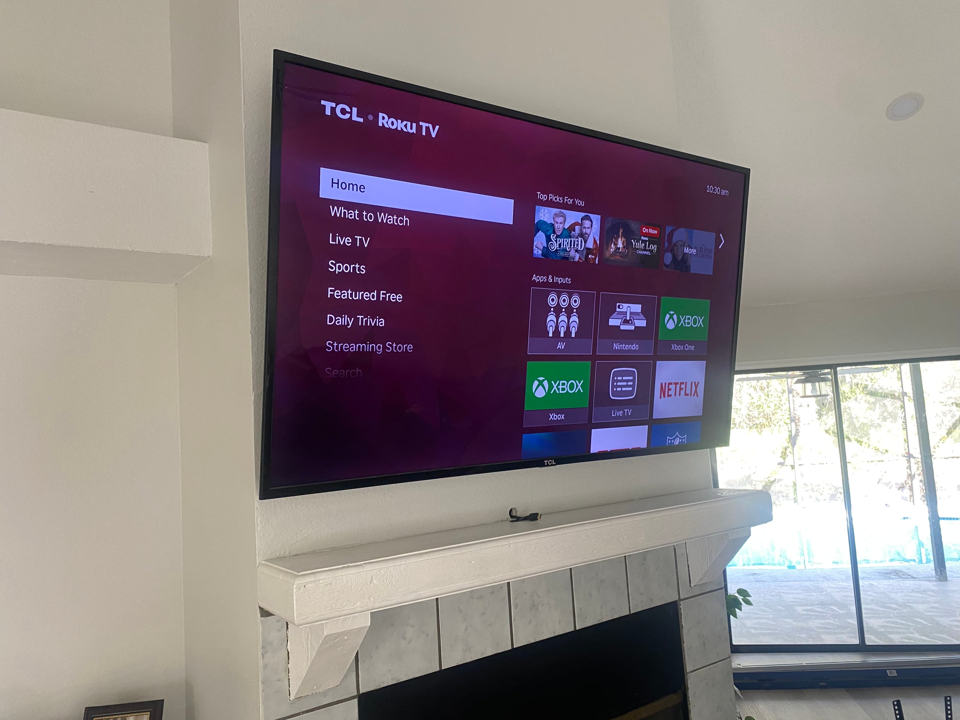Wall-mounted TV installed above a fireplace